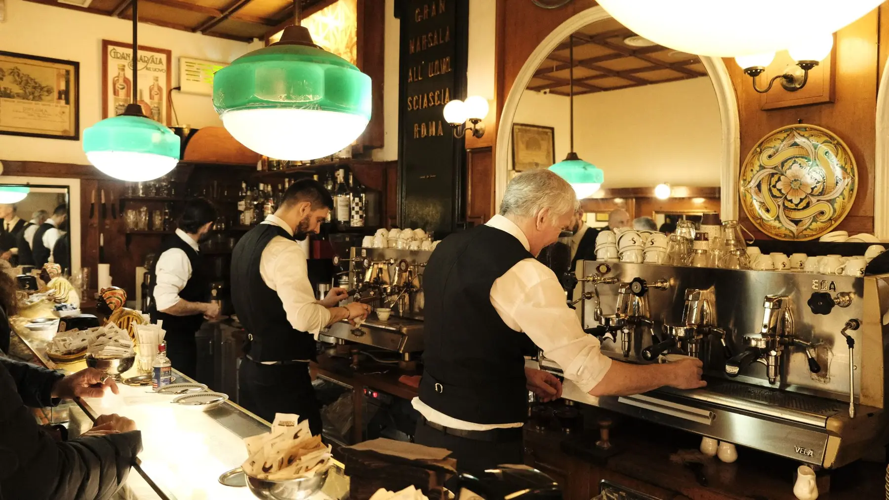 Baristas au travail derrière le comptoir d’un café européen