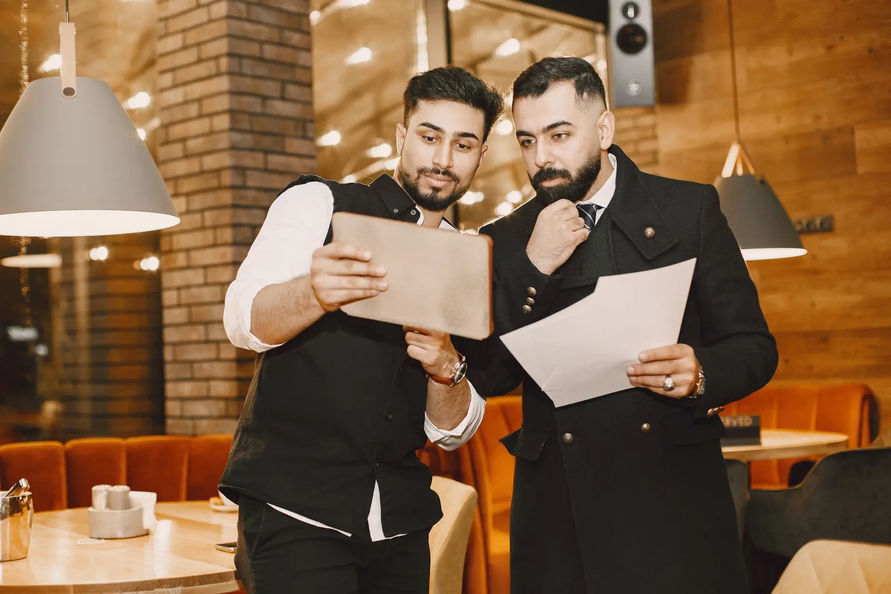 Professionnels de l’horeca comparant des conditions fournisseurs sur une tablette